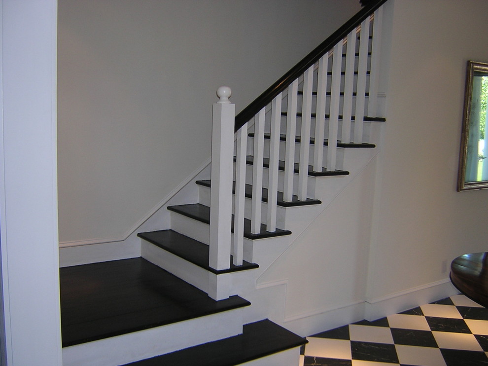 Photo of a traditional wood l-shaped staircase in New York with wood risers and wood railing.