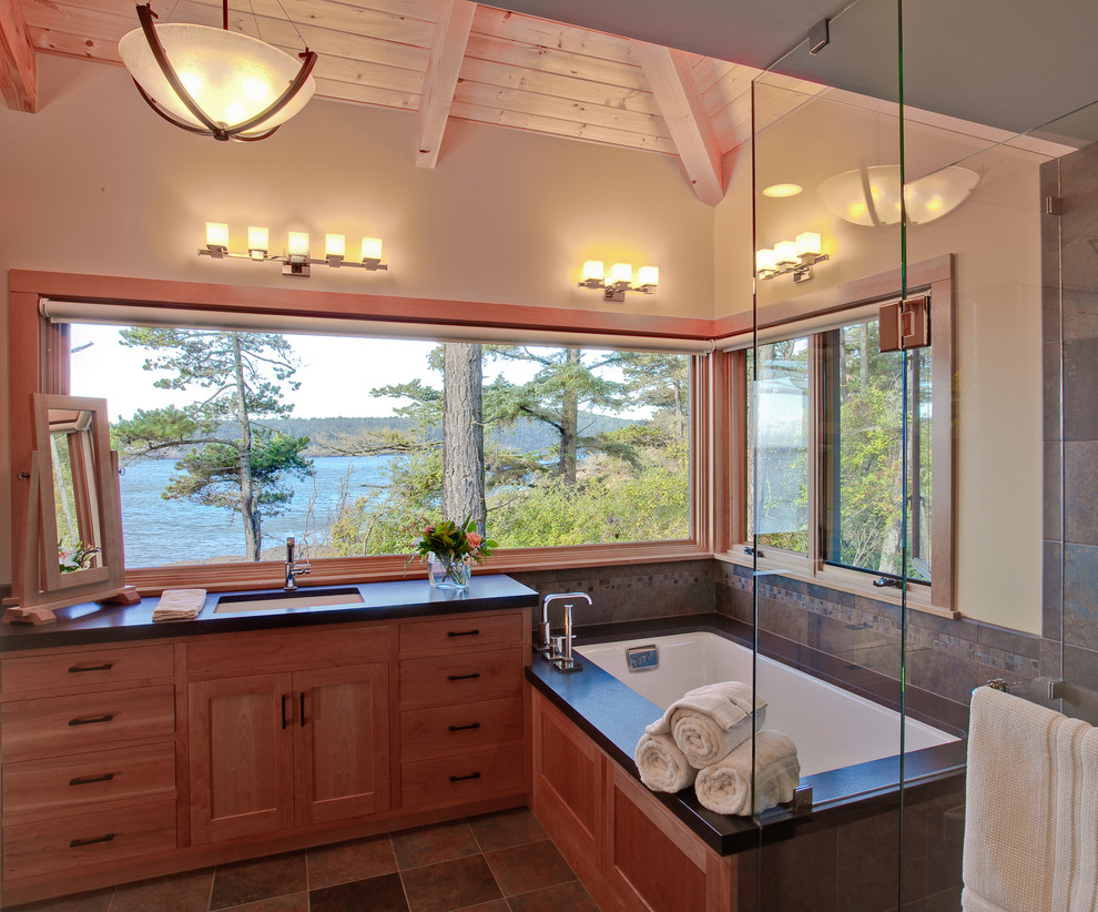 Country bathroom in Seattle with an undermount sink, flat-panel cabinets, medium wood cabinets, a curbless shower, brown tile, mosaic tile, beige walls and an undermount tub.