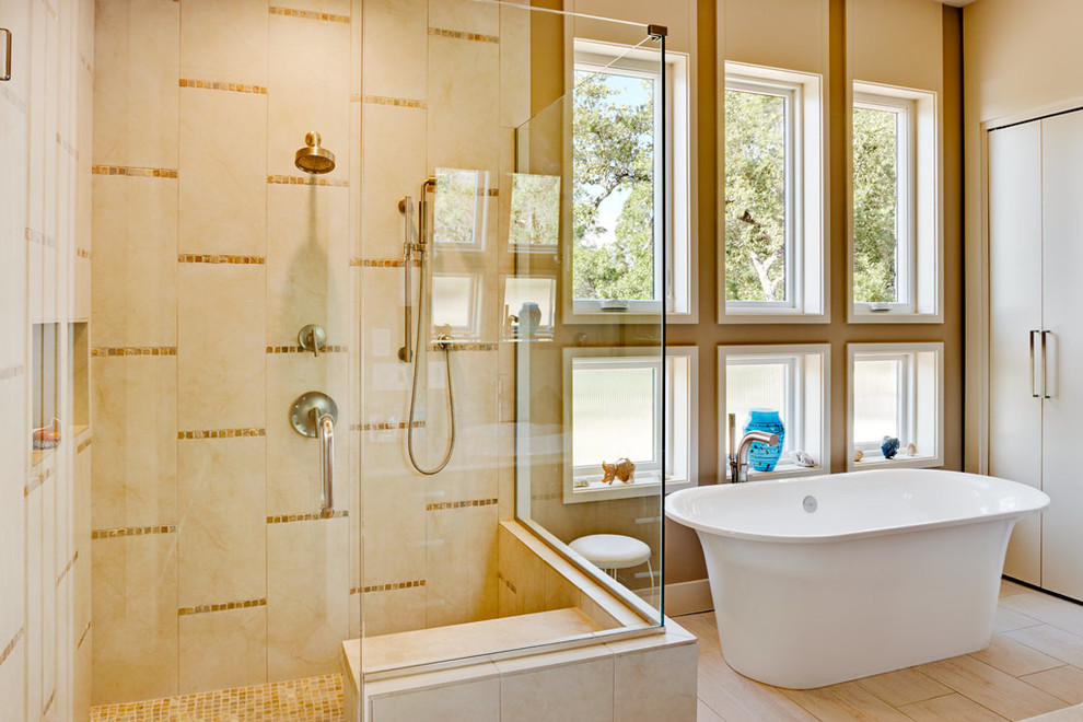 Inspiration for a contemporary bathroom in Austin with a freestanding tub, a double shower, beige tile and beige walls.