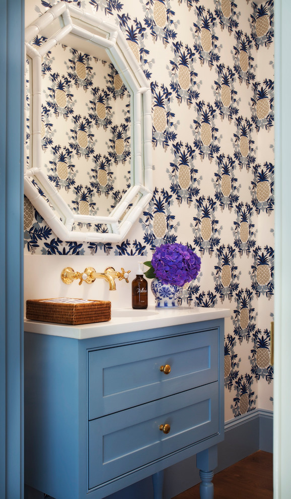 This is an example of a tropical powder room in Boston with beaded inset cabinets, blue cabinets, engineered quartz benchtops, medium hardwood floors and brown floor.