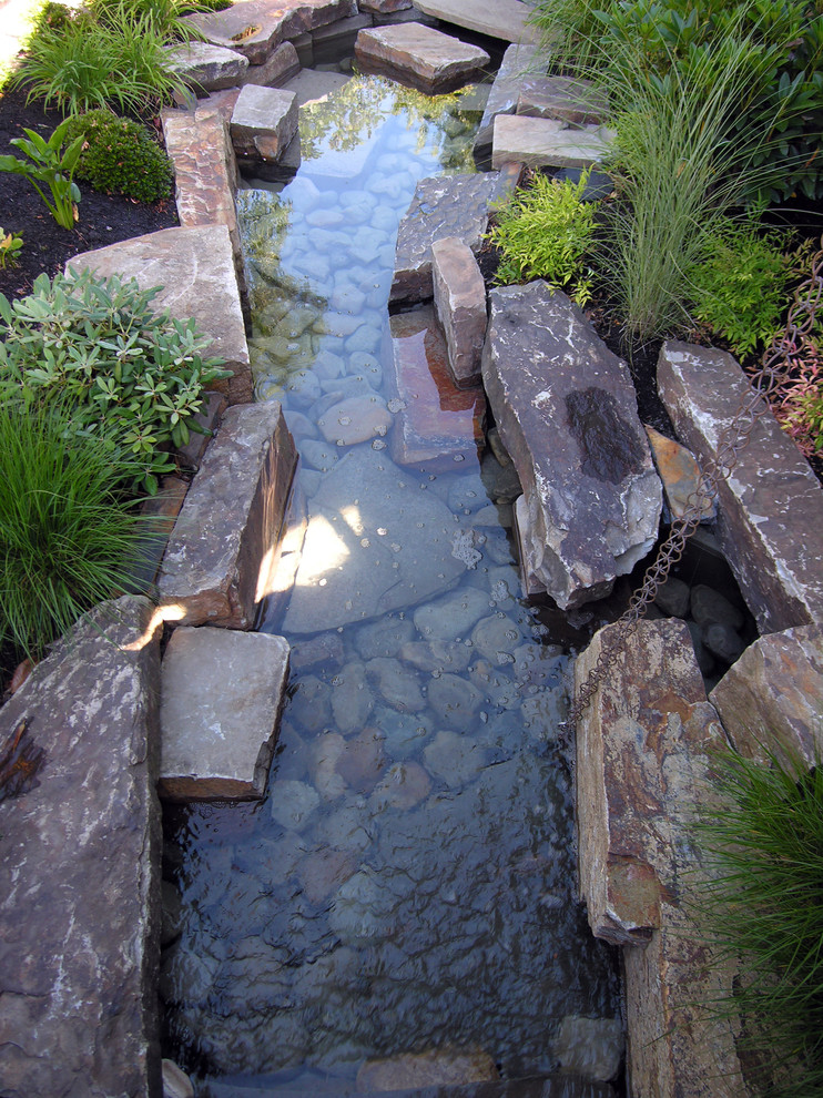 Design ideas for a mid-sized country backyard garden in Portland with a water feature.