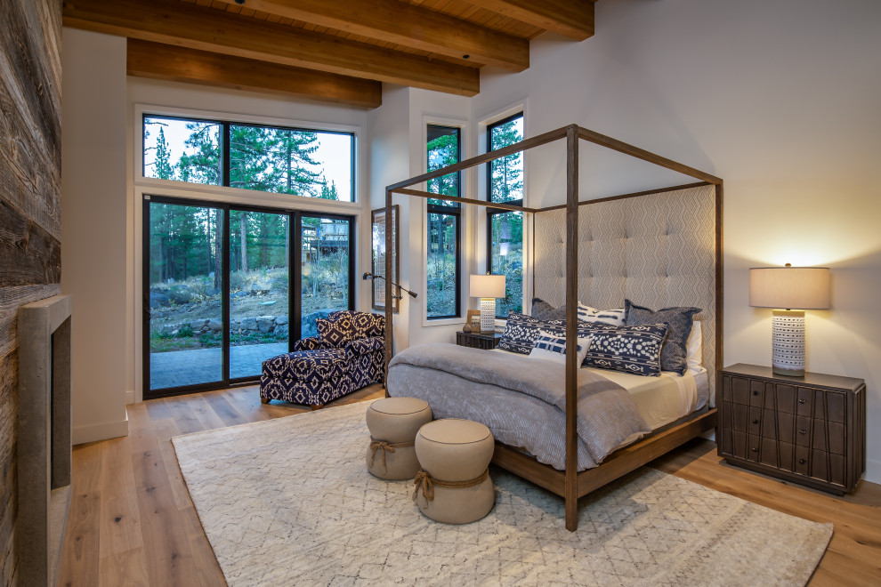 Mountain style medium tone wood floor, brown floor, exposed beam and wood ceiling bedroom photo in Other with white walls