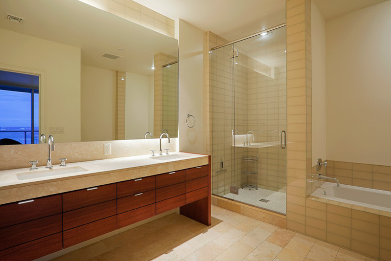 Large transitional master beige tile beige floor drop-in bathtub photo in Denver with flat-panel cabinets, medium tone wood cabinets, white walls, an undermount sink and a hinged shower door