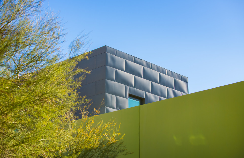 Photo of a contemporary three-storey green exterior in Las Vegas.