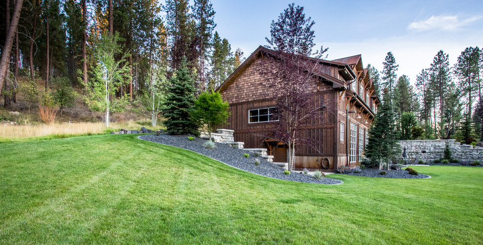 Photo of a huge rustic hillside concrete paver retaining wall landscape.