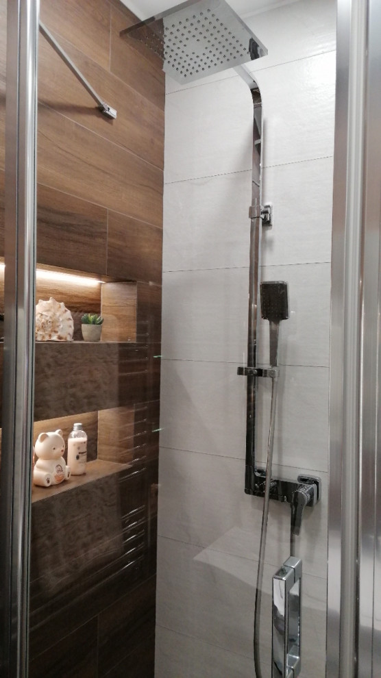 Example of a small 3/4 brown tile and matchstick tile porcelain tile, brown floor and single-sink corner shower design in Other with white cabinets, brown walls, a wall-mount sink, a hinged shower door and a floating vanity