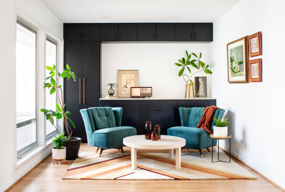Inspiration for a small midcentury formal living room in Raleigh with white walls, medium hardwood flooring, no fireplace, no tv and brown floors.