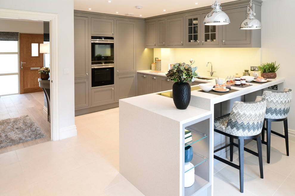 This is an example of a contemporary kitchen in London with porcelain floors and beige floor.