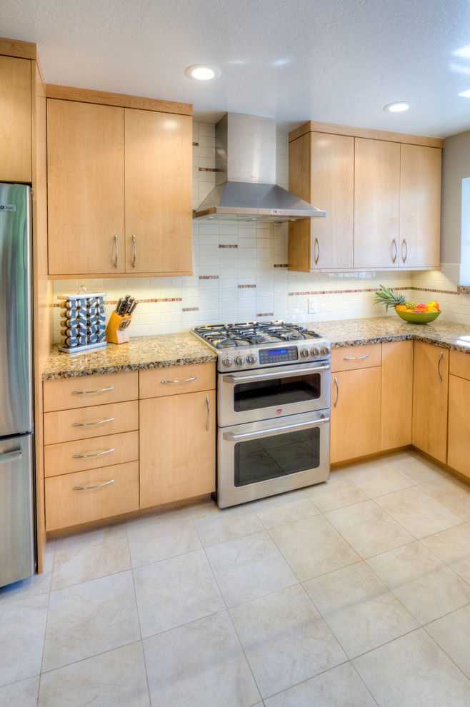 Photo of a contemporary galley eat-in kitchen in San Francisco with an undermount sink, flat-panel cabinets, light wood cabinets, quartz benchtops, multi-coloured splashback, porcelain splashback and stainless steel appliances.
