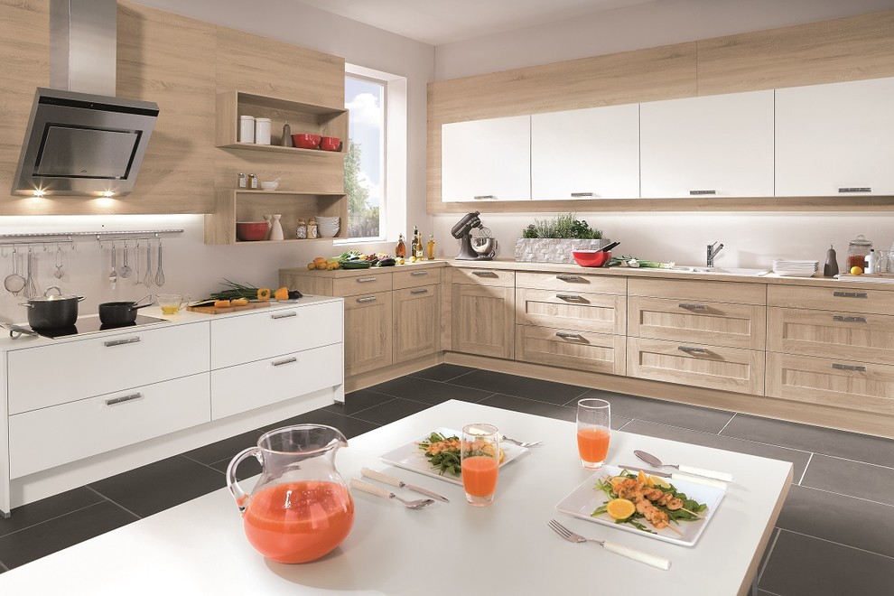 Design ideas for a large country l-shaped eat-in kitchen in Other with recessed-panel cabinets, light wood cabinets and white splashback.