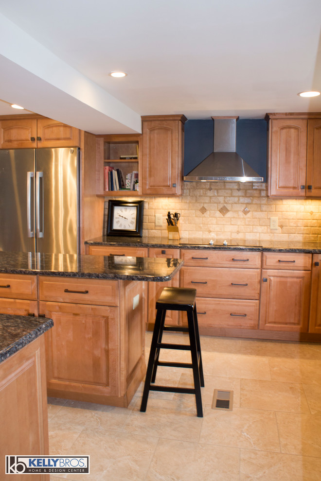 Large transitional l-shaped ceramic tile eat-in kitchen photo in Cincinnati with an undermount sink, raised-panel cabinets, light wood cabinets, granite countertops, beige backsplash, stone tile backsplash, stainless steel appliances and an island