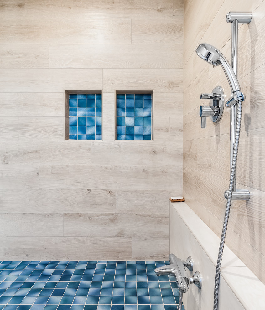 Inspiration for a large transitional master bathroom in San Francisco with flat-panel cabinets, a japanese tub, a shower/bathtub combo, a two-piece toilet, beige tile, a vessel sink, a hinged shower door and blue benchtops.