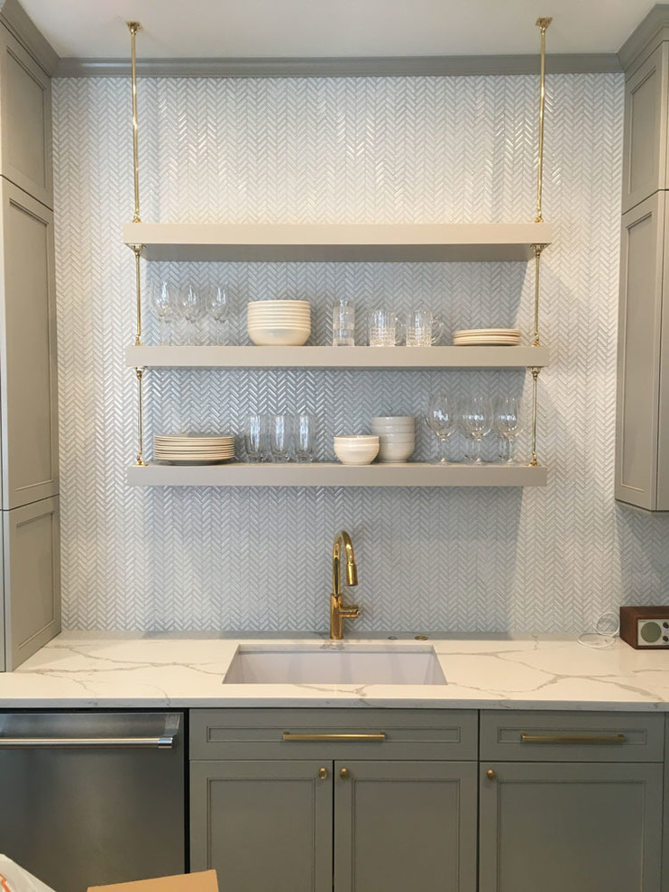 Design ideas for a mid-sized transitional galley separate kitchen in Chicago with an undermount sink, recessed-panel cabinets, grey cabinets, quartz benchtops, white splashback and mosaic tile splashback.
