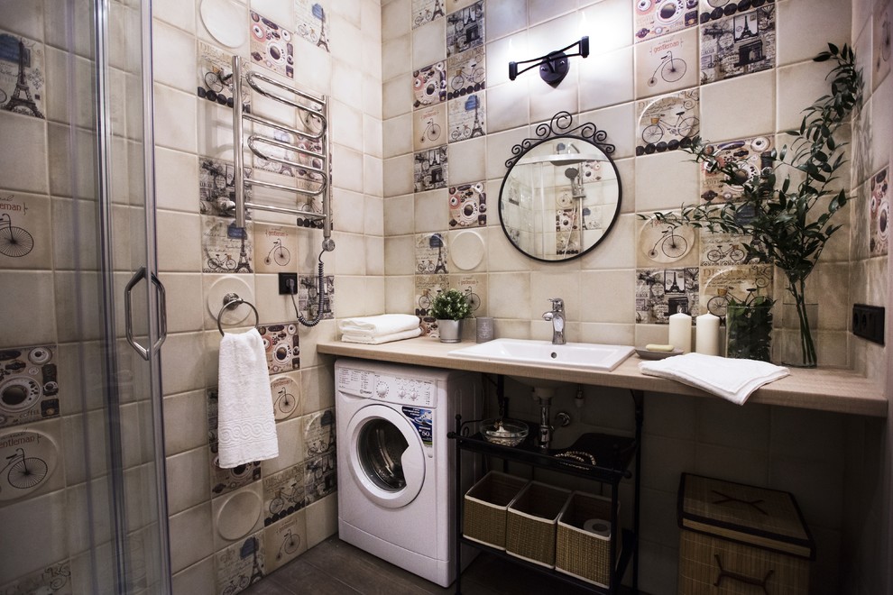 This is an example of a small industrial 3/4 bathroom in Saint Petersburg with a corner shower, beige tile, ceramic tile, beige walls, porcelain floors, an undermount sink, brown floor, a sliding shower screen, a one-piece toilet and wood benchtops.