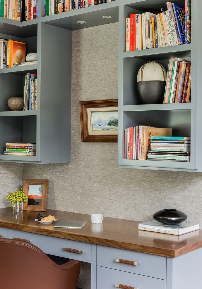 Photo of a mid-sized transitional study room in Boston with grey walls, a built-in desk and medium hardwood floors.