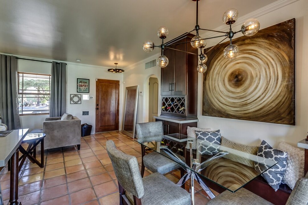 Inspiration for a mid-sized transitional terra-cotta tile and brown floor great room remodel in Phoenix with beige walls and no fireplace