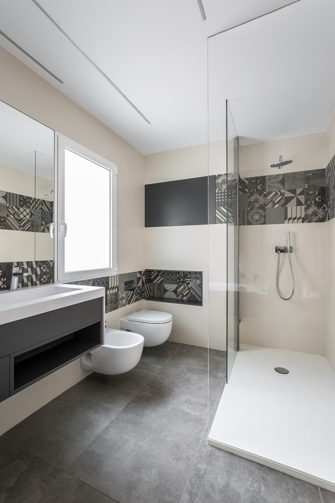 Mid-sized contemporary 3/4 bathroom in Valencia with flat-panel cabinets, black cabinets, a corner shower, a bidet, beige tile, black and white tile, beige walls and a trough sink.
