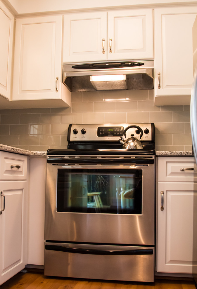 Inspiration for a small transitional u-shaped light wood floor kitchen remodel in Baltimore with an undermount sink, raised-panel cabinets, white cabinets and no island