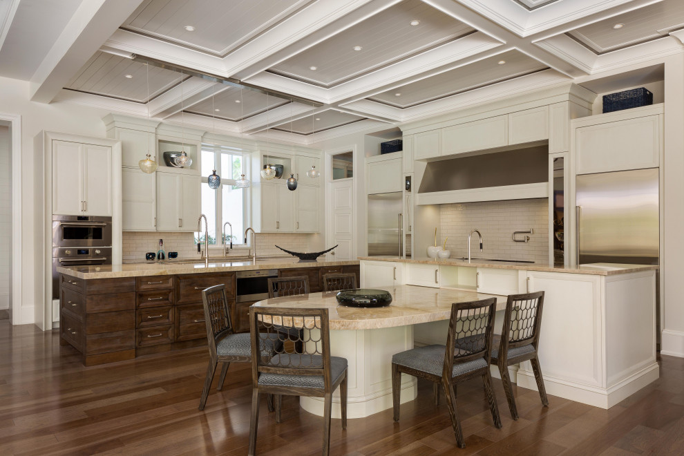 Eat-in kitchen - large transitional l-shaped dark wood floor eat-in kitchen idea in Miami with beige cabinets, beige backsplash, stainless steel appliances and two islands