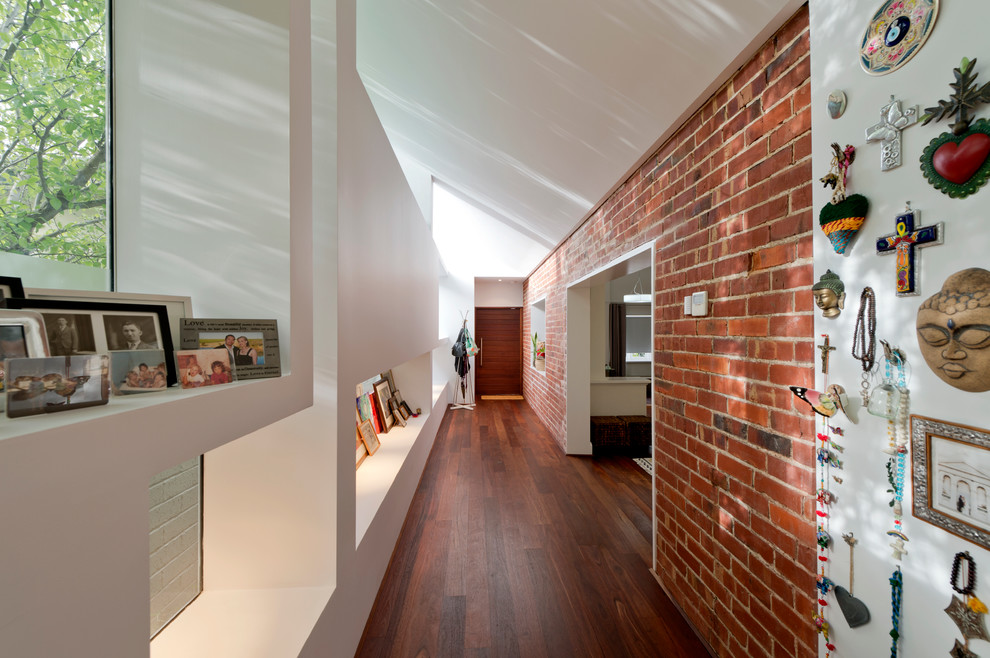 Mid-sized eclectic hallway in Perth with medium hardwood floors and multi-coloured walls.