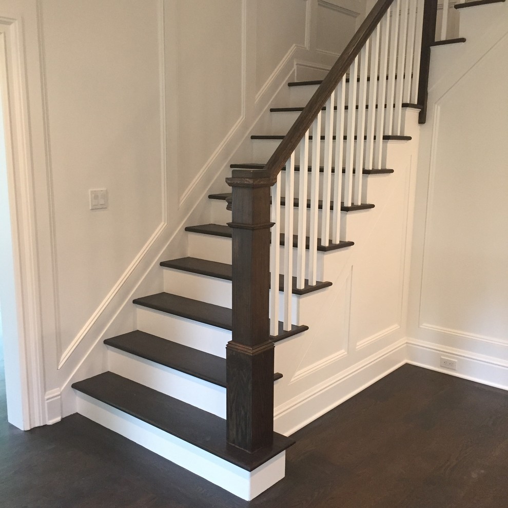 Photo of a mid-sized traditional wood l-shaped staircase in New York with painted wood risers and wood railing.