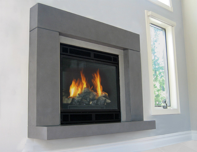 This is a concrete fireplace surround by Trueform Concrete. This project features the Beam Fireplace with a  floating hearth cast in a light grey concrete.