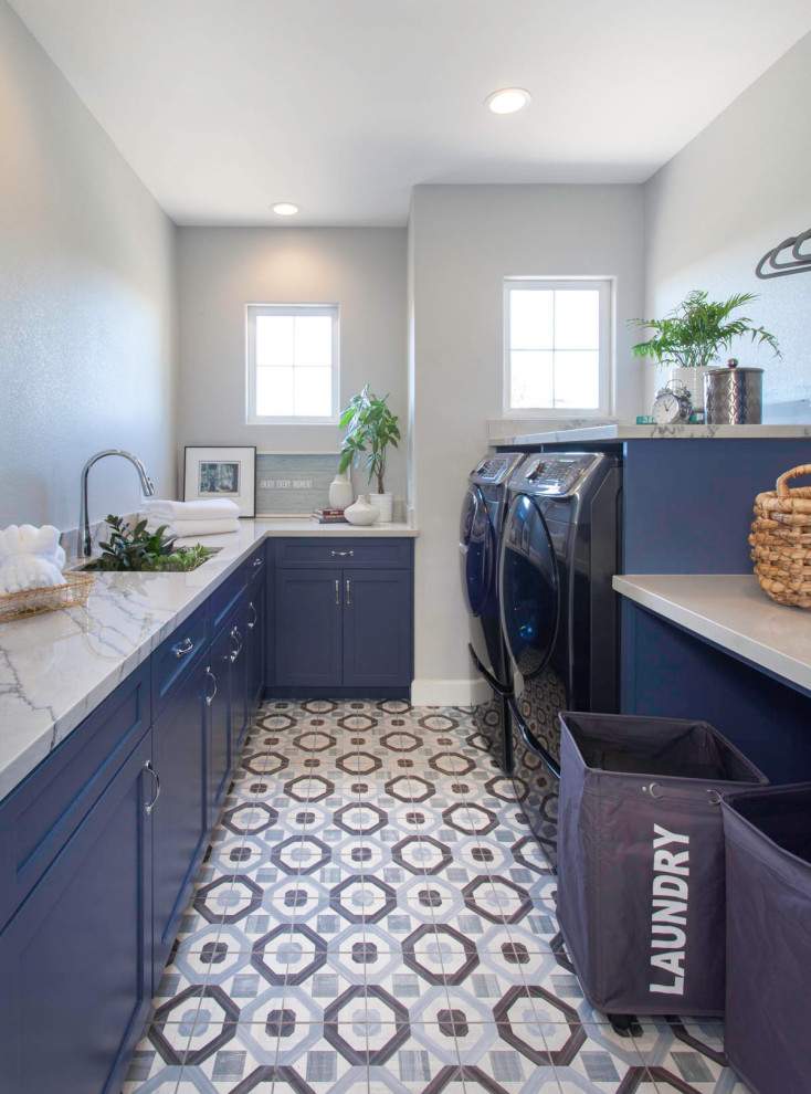 Design ideas for a mid-sized modern galley dedicated laundry room in San Diego with flat-panel cabinets, blue cabinets, white walls, ceramic floors and multi-coloured floor.