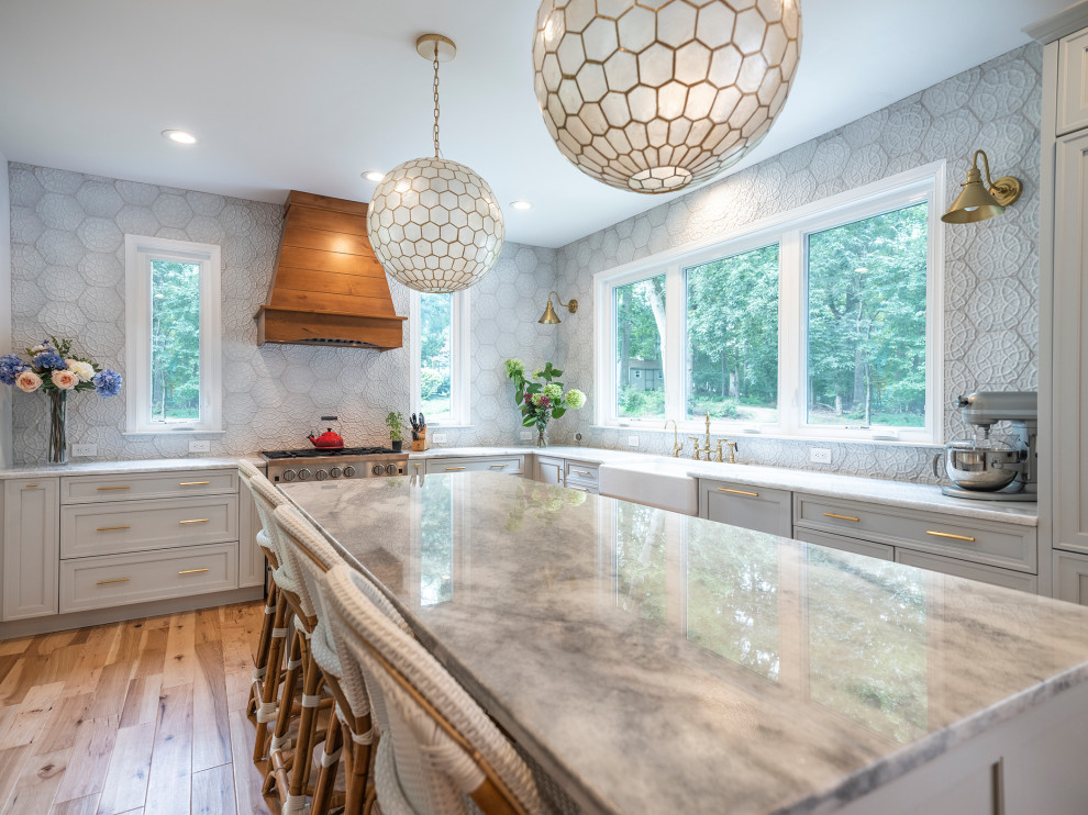 Inspiration for a mid-sized transitional l-shaped separate kitchen in DC Metro with a farmhouse sink, recessed-panel cabinets, grey cabinets, granite benchtops, white splashback, stainless steel appliances, medium hardwood floors, with island, brown floor and grey benchtop.
