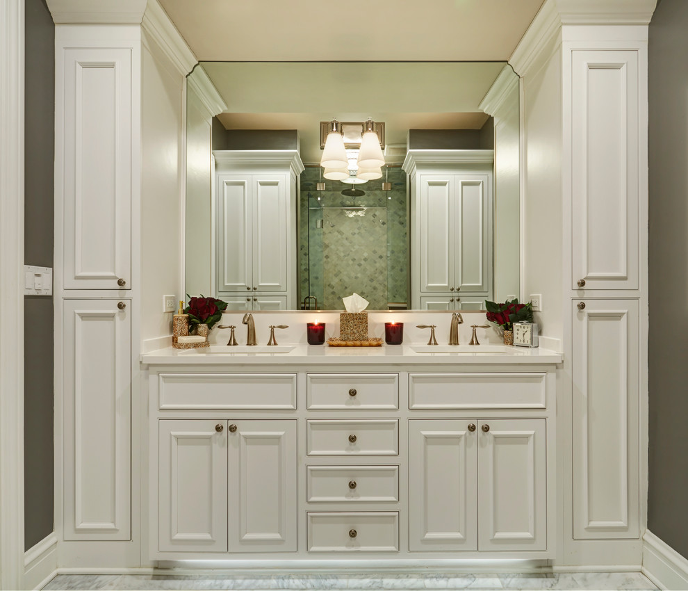 Design ideas for a mid-sized transitional master bathroom in Chicago with recessed-panel cabinets, white cabinets, white tile, stone tile, grey walls, marble floors, an undermount sink and white floor.