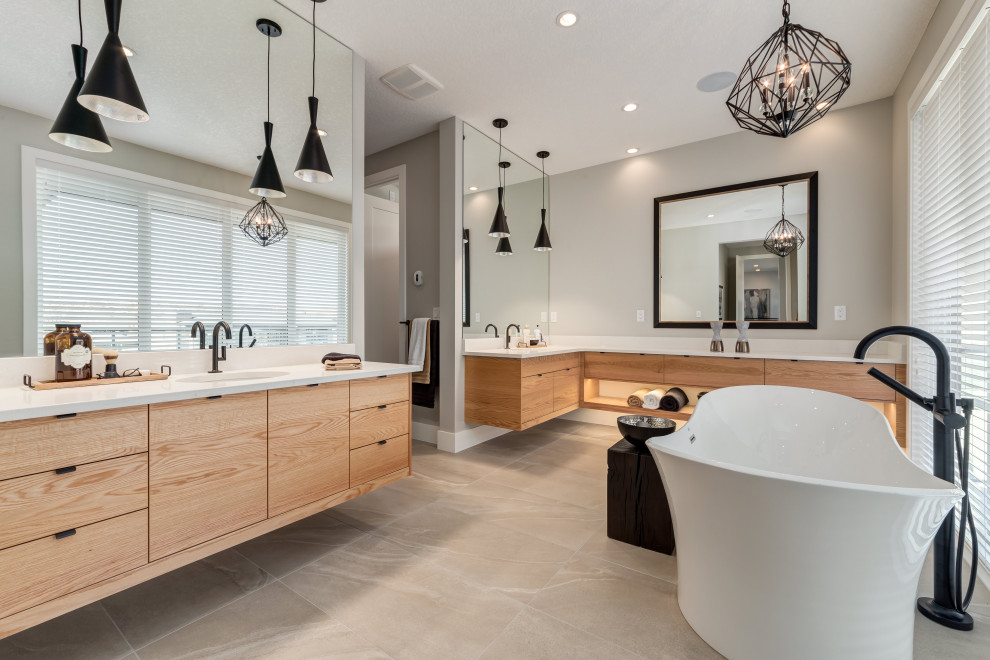 Inspiration for an expansive contemporary master bathroom in Orlando with flat-panel cabinets, medium wood cabinets, a freestanding tub, grey walls, an undermount sink, solid surface benchtops and brown floor.