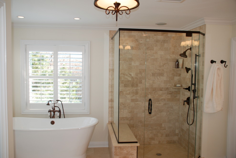 This is an example of a mid-sized traditional master bathroom in Chicago with an undermount sink, recessed-panel cabinets, white cabinets, marble benchtops, a freestanding tub, an open shower, a two-piece toilet, beige tile, stone tile, beige walls and marble floors.