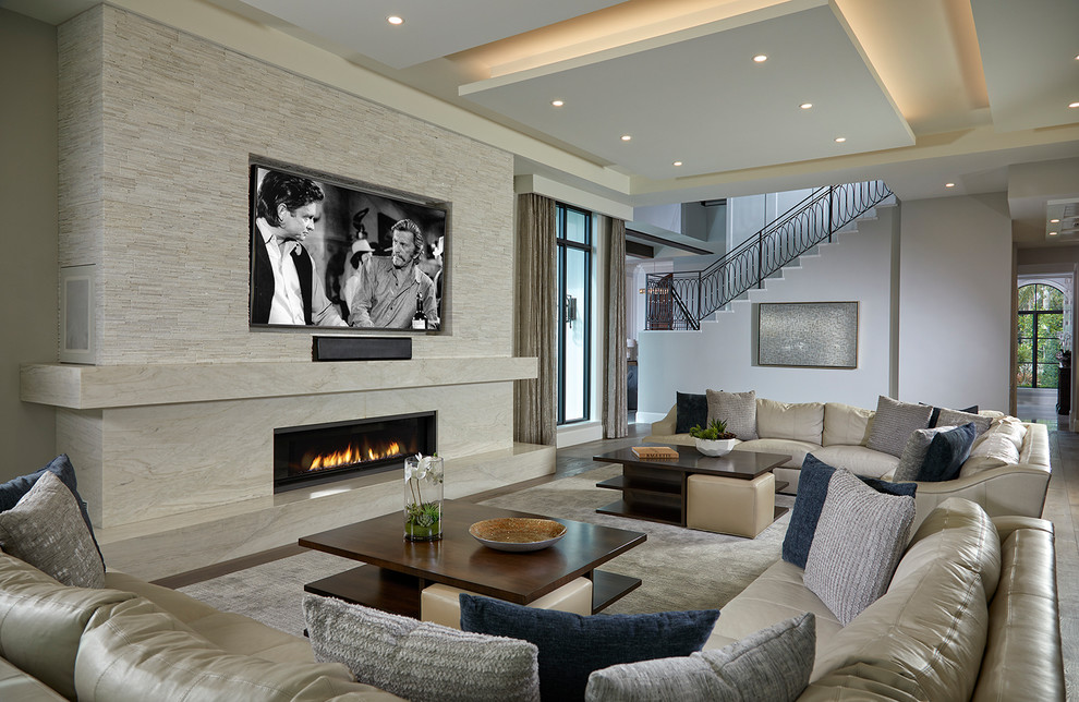Photo of a transitional open concept family room in Miami with grey walls, dark hardwood floors, a ribbon fireplace and brown floor.