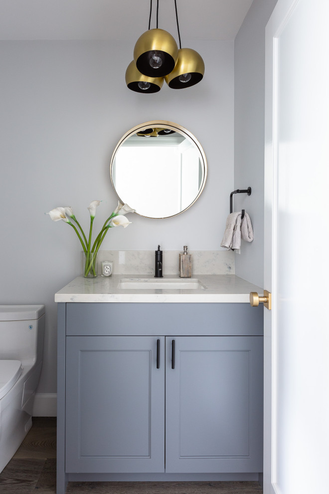 Design ideas for a small classic cloakroom in San Francisco with shaker cabinets, grey cabinets, a one-piece toilet, white tiles, stone slabs, grey walls, medium hardwood flooring, a submerged sink, quartz worktops, grey floors, white worktops and a built in vanity unit.
