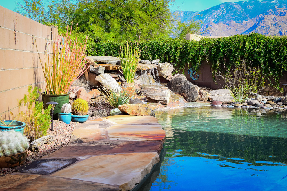 Example of a large backyard concrete paver and custom-shaped hot tub design in Phoenix
