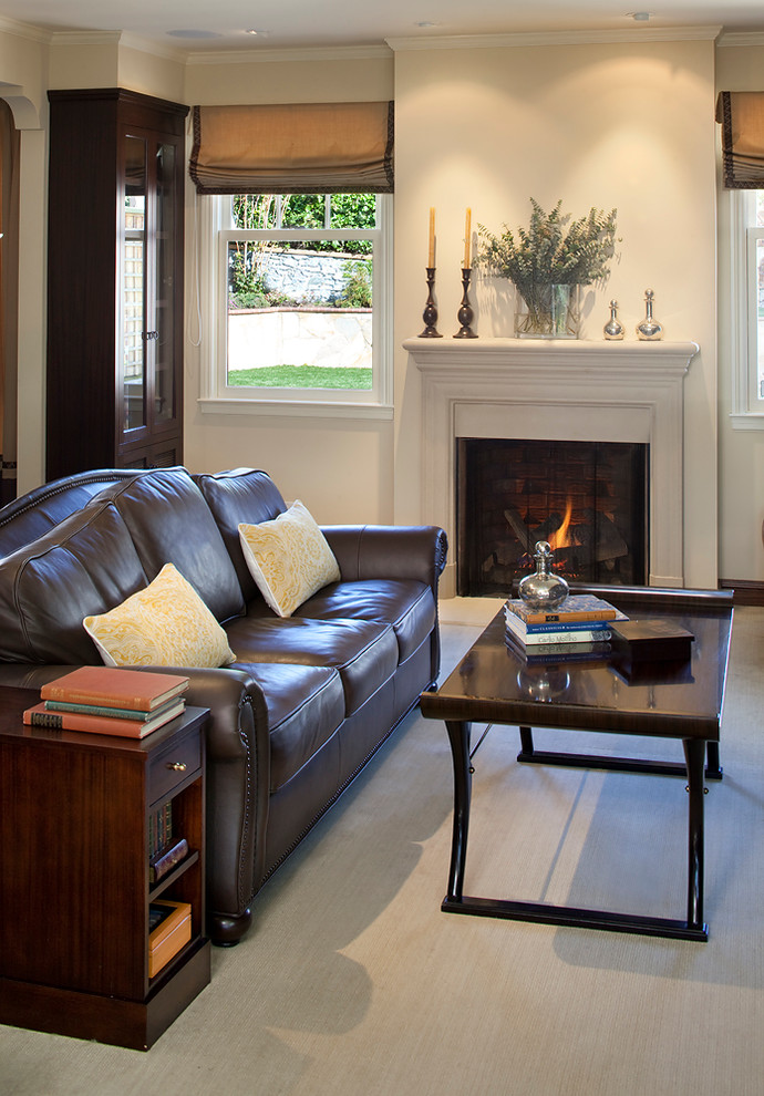 Photo of a small traditional enclosed living room in San Francisco with carpet, a standard fireplace, a stone fireplace surround and a concealed tv.