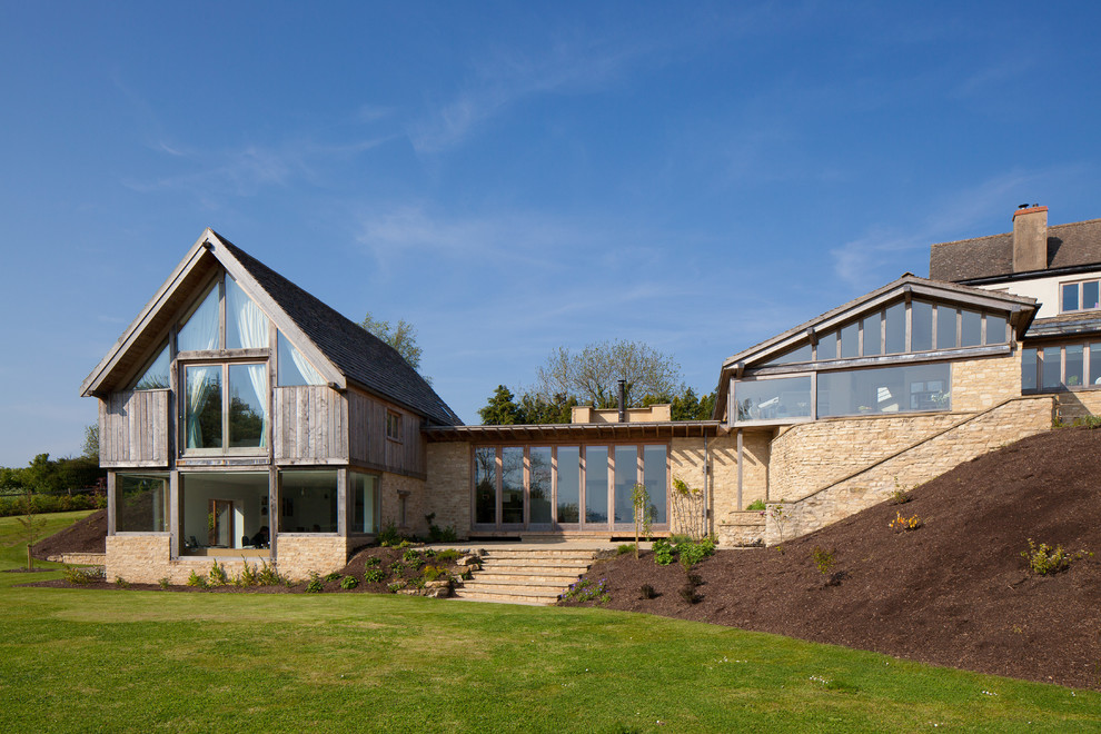 This is an example of a contemporary two-storey exterior in Gloucestershire with mixed siding and a gable roof.