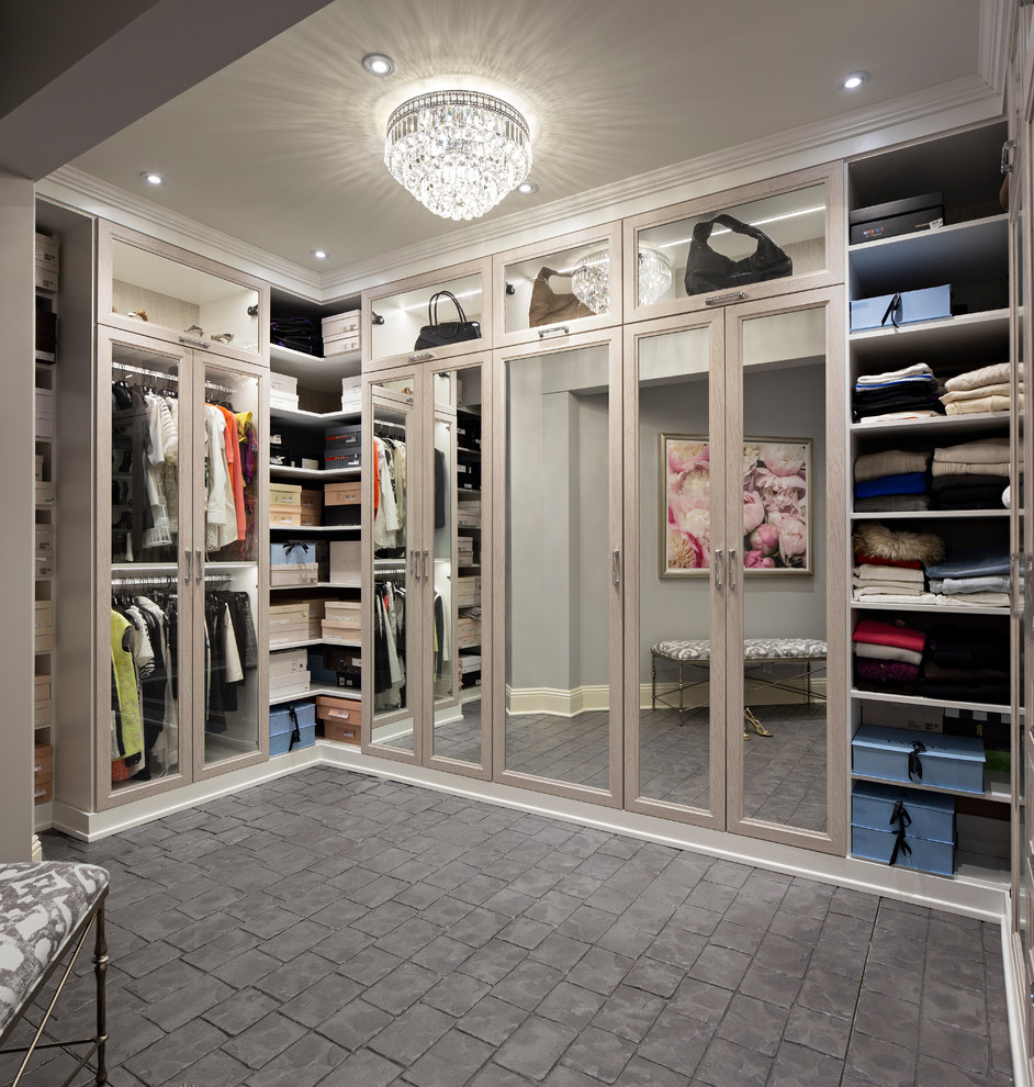Inspiration for a transitional storage and wardrobe in Other with glass-front cabinets, light wood cabinets, concrete floors and grey floor.