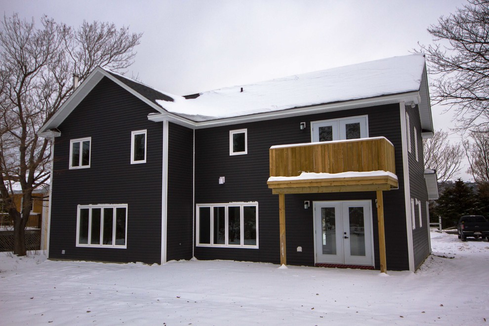Example of a mid-sized transitional two-story vinyl gray home design design