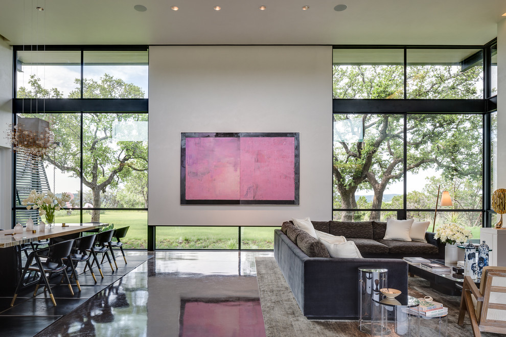 Design ideas for a contemporary formal open concept living room in Austin with white walls and concrete floors.