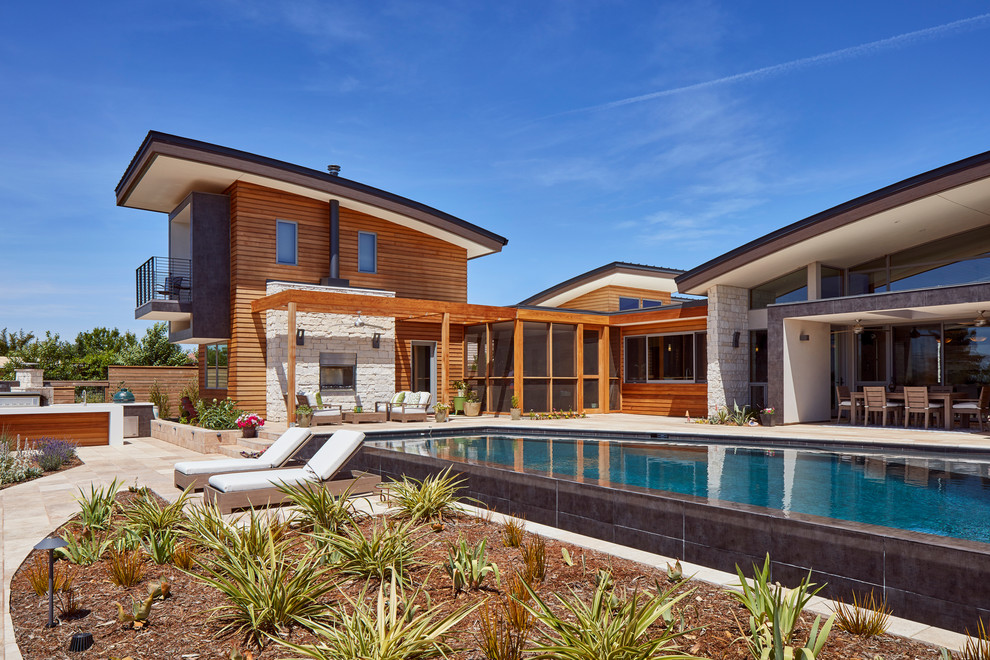 This is an example of a large contemporary two-storey exterior in Sacramento with wood siding.