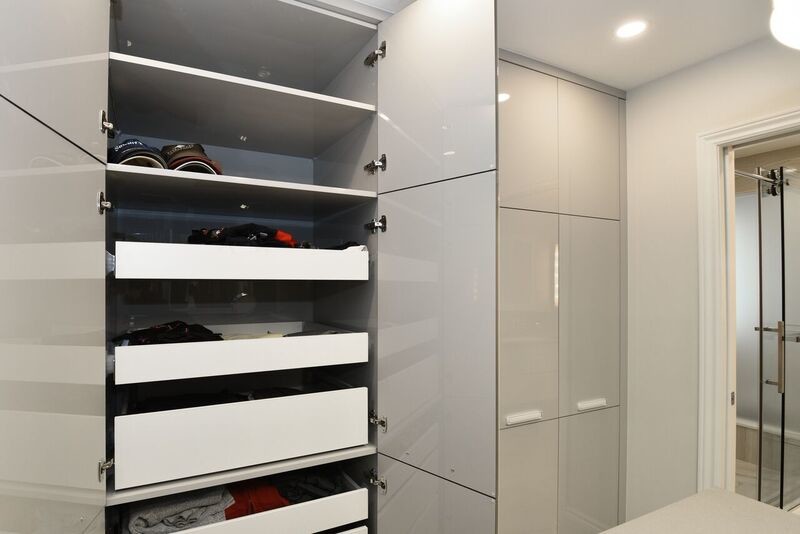 This is an example of a large contemporary gender-neutral dressing room in Ottawa with flat-panel cabinets, grey cabinets and ceramic floors.