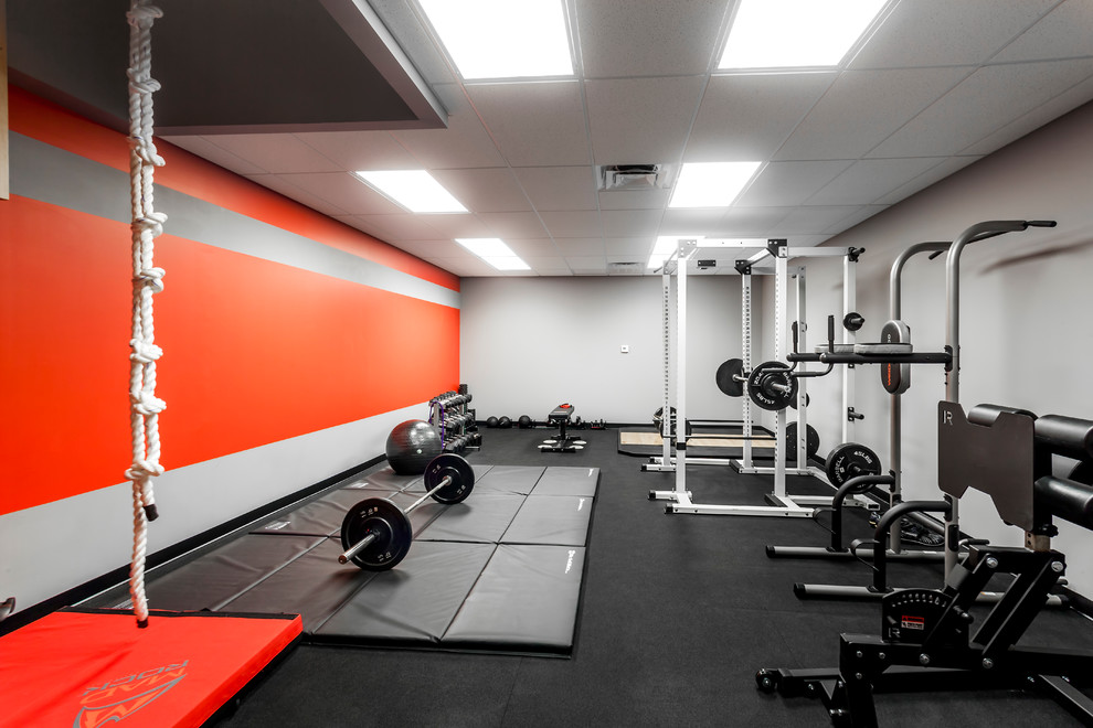 Design ideas for a large modern home weight room in Orlando with grey walls and black floor.
