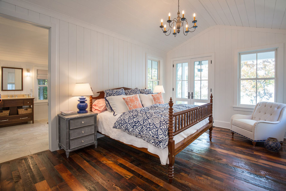 Photo of a large country master bedroom in Other with white walls, medium hardwood floors and no fireplace.