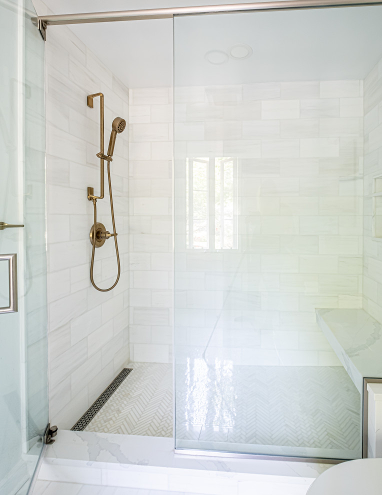 Mid-sized elegant marble floor, white floor and single-sink shower bench photo in New York with shaker cabinets, gray cabinets, a one-piece toilet, white walls, an undermount sink, quartz countertops, a hinged shower door, white countertops and a built-in vanity