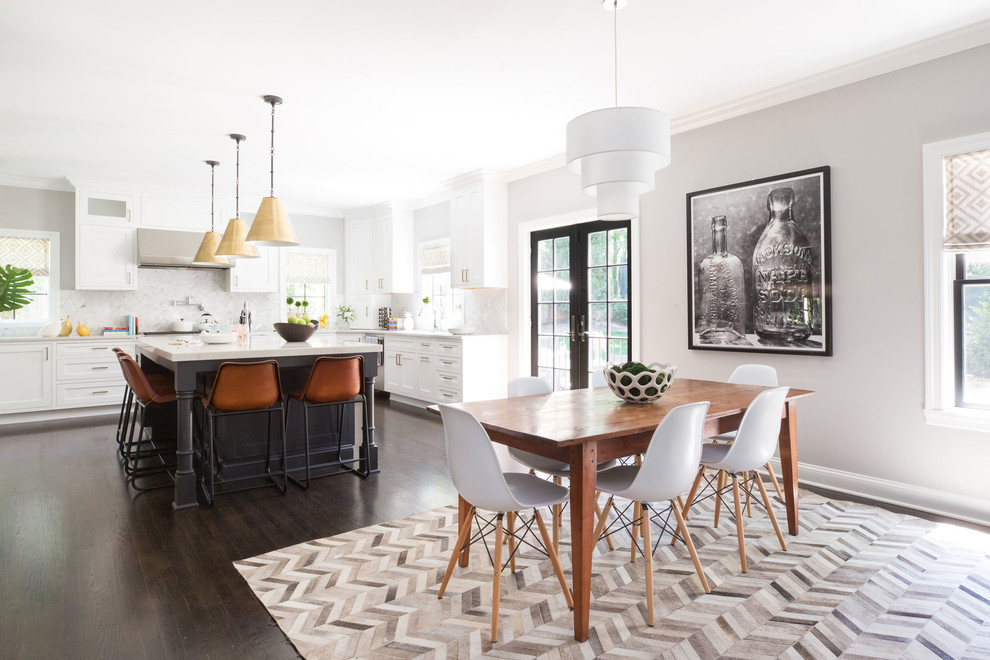 Photo of a transitional kitchen/dining combo in New York with grey walls, dark hardwood floors and brown floor.