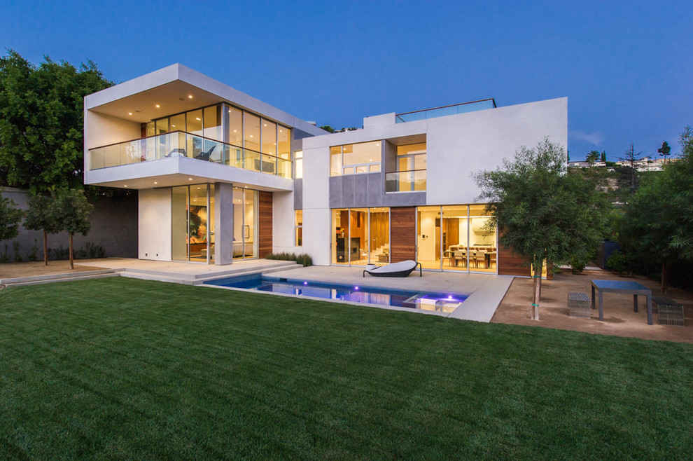 Large contemporary two-storey white house exterior in Los Angeles with mixed siding and a flat roof.