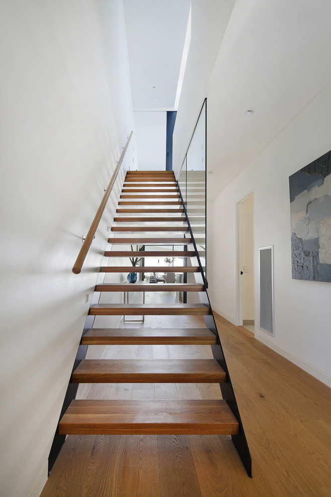 Large contemporary wood straight staircase in Melbourne with mixed railing.