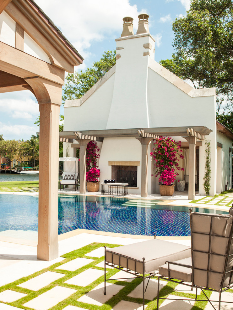Mediterranean backyard custom-shaped pool in Miami.