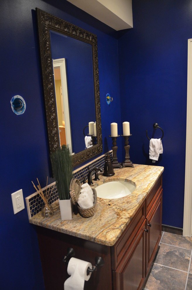 Design ideas for a traditional 3/4 bathroom in Philadelphia with brown cabinets, a corner shower, a one-piece toilet, blue walls, an integrated sink, engineered quartz benchtops, a hinged shower door, multi-coloured benchtops, a single vanity and a freestanding vanity.