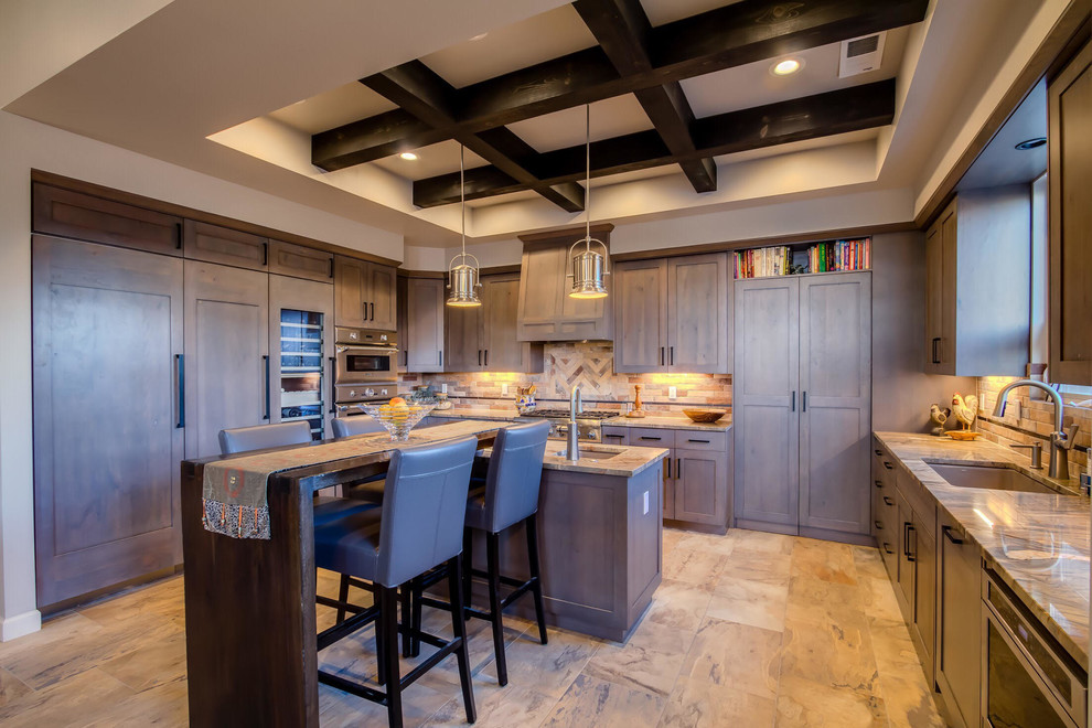 Inspiration for a transitional eat-in kitchen in Albuquerque with an integrated sink, grey cabinets, granite benchtops, beige splashback, stainless steel appliances, multiple islands and beige floor.